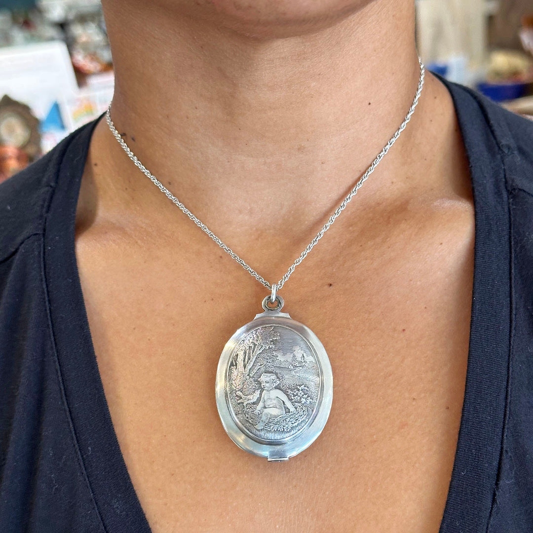 Victorian era French silver locket with baby and bird nest motif