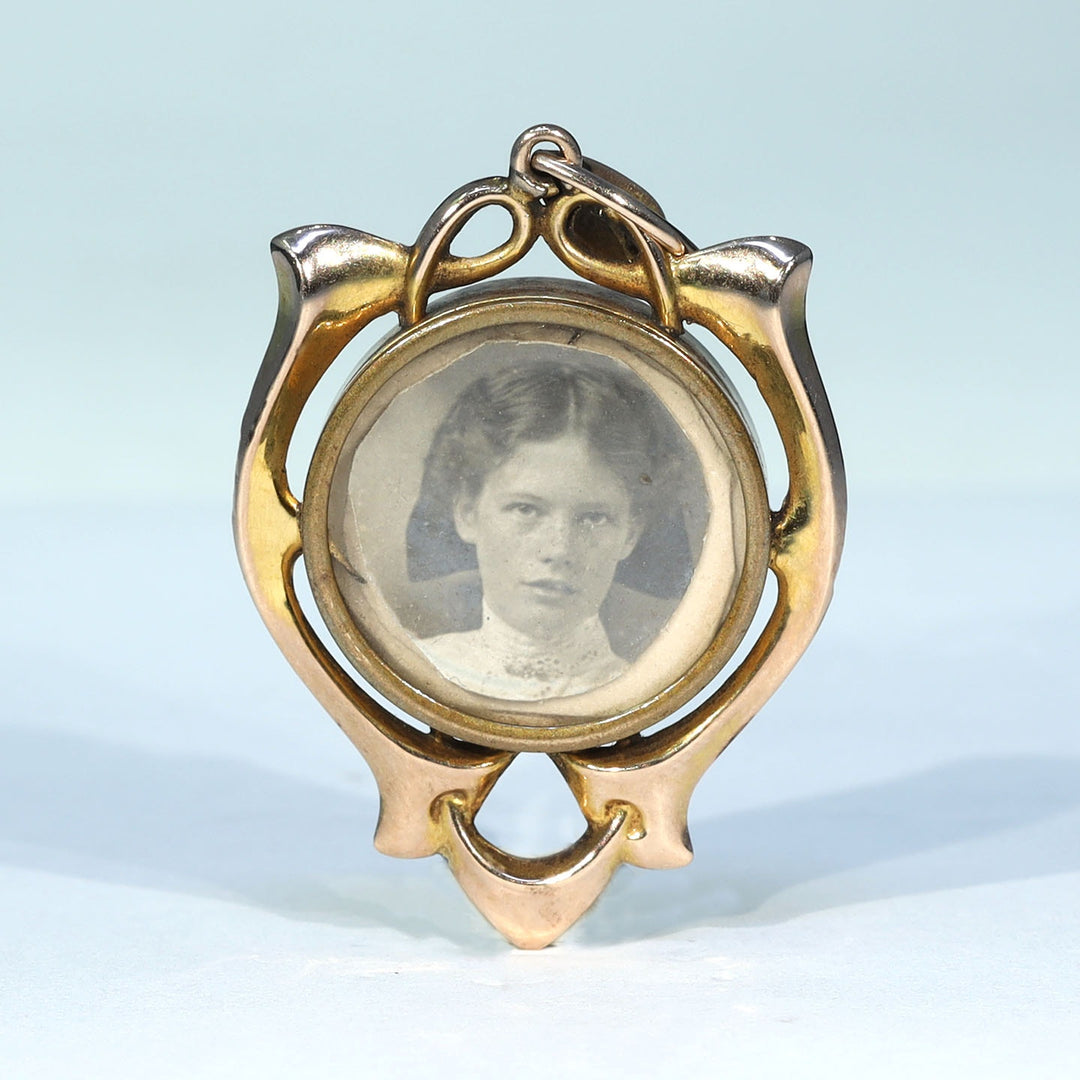 English gold drop frame locket with original Victorian portraits