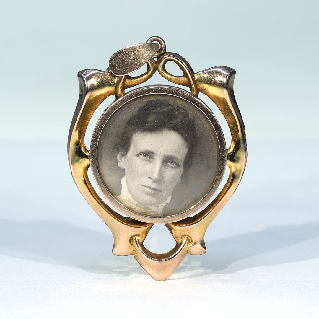 Art Nouveau gold locket with flowing floral inspired frame