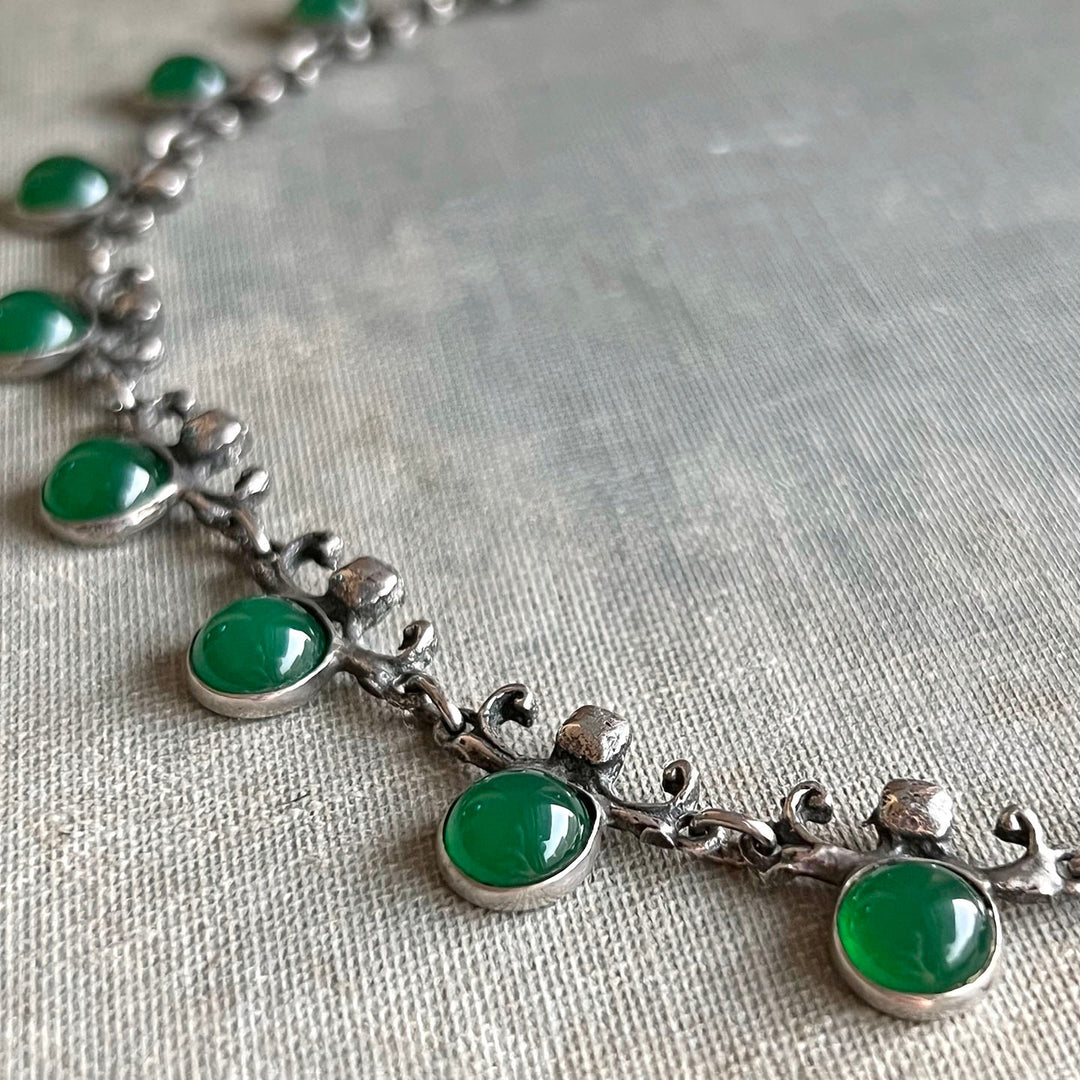 Close view of green glass drop necklace