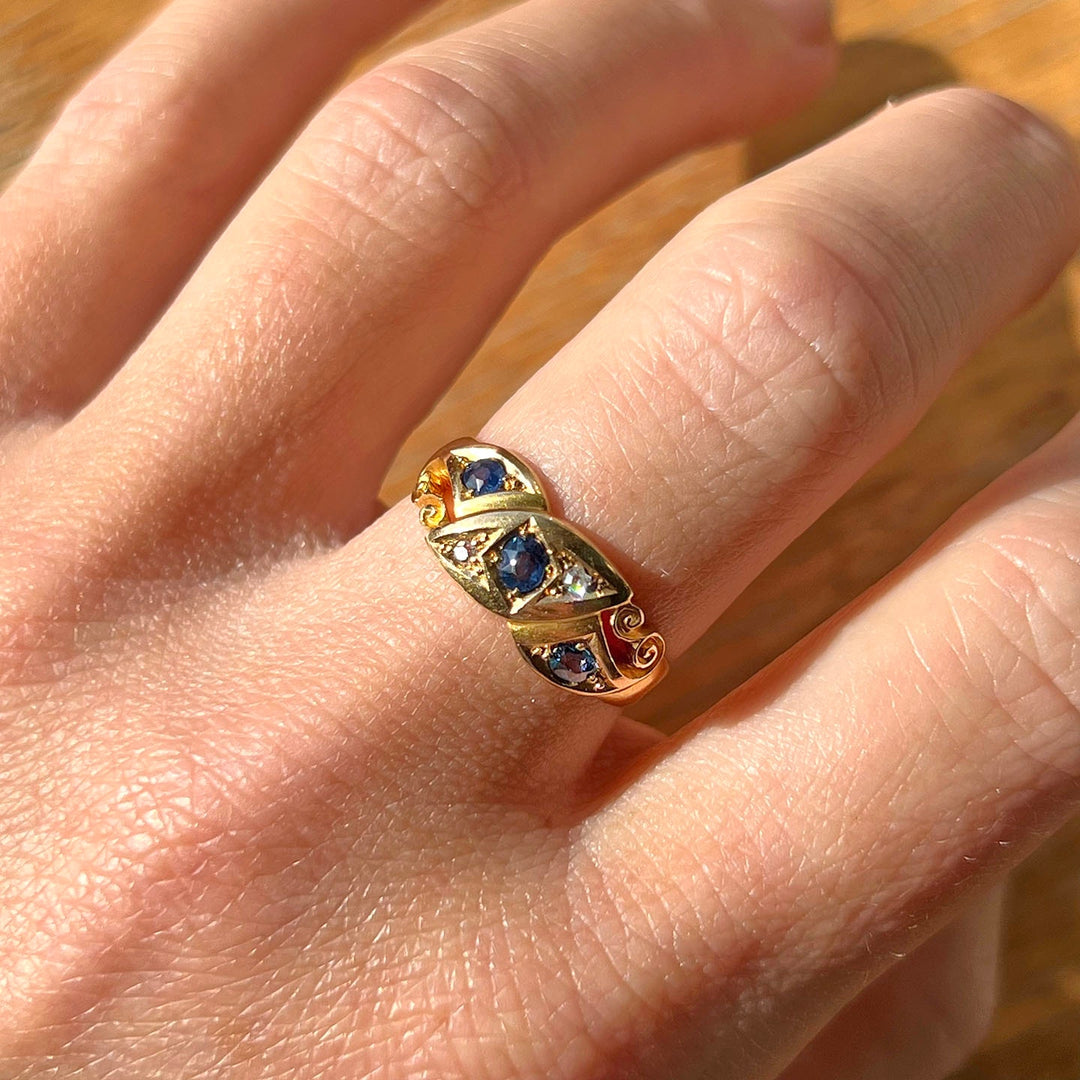 Antique sapphire and diamond ring on hand