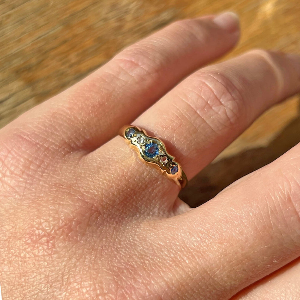 Edwardian sapphire and diamond ring worn on hand five stone design