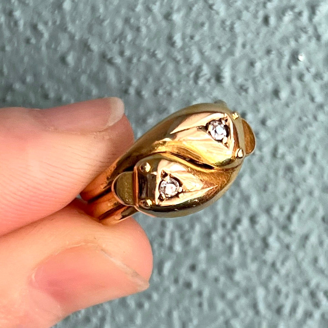 Detail of diamond set snake heads antique ring