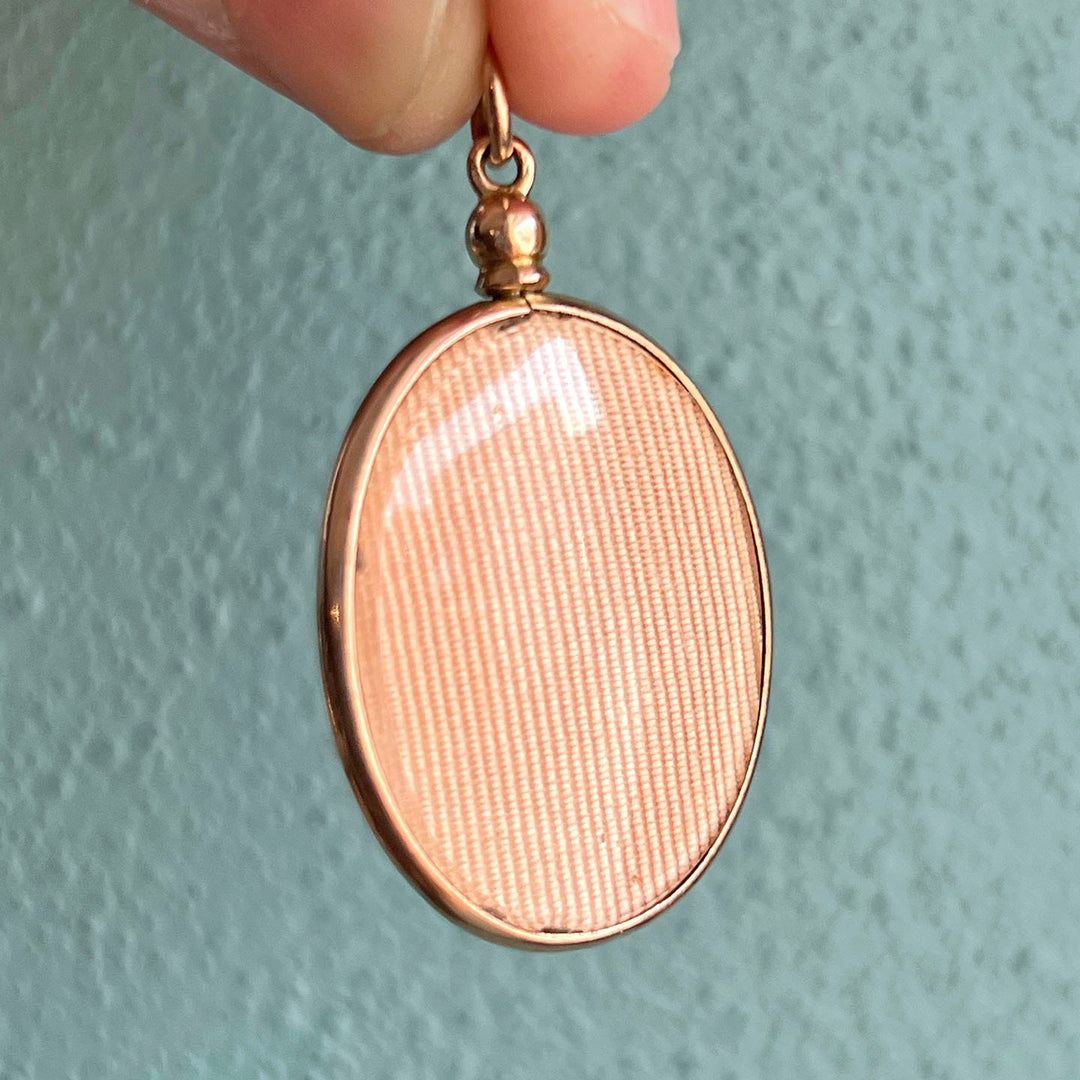 Close view of engraved gold oval locket
