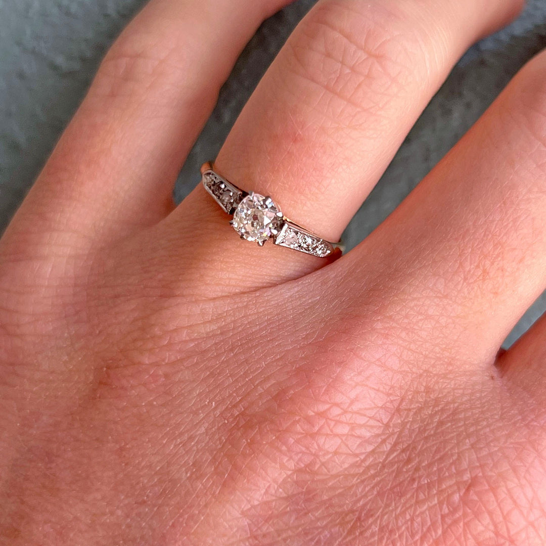 Antique Edwardian diamond engagement ring in 18K gold and platinum on hand