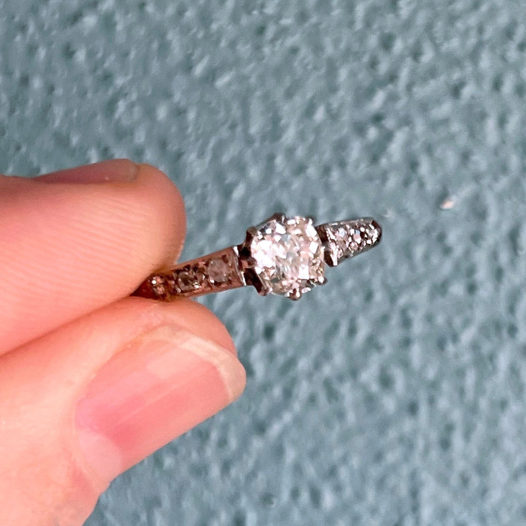 Close up of antique Edwardian diamond cluster in gold and platinum