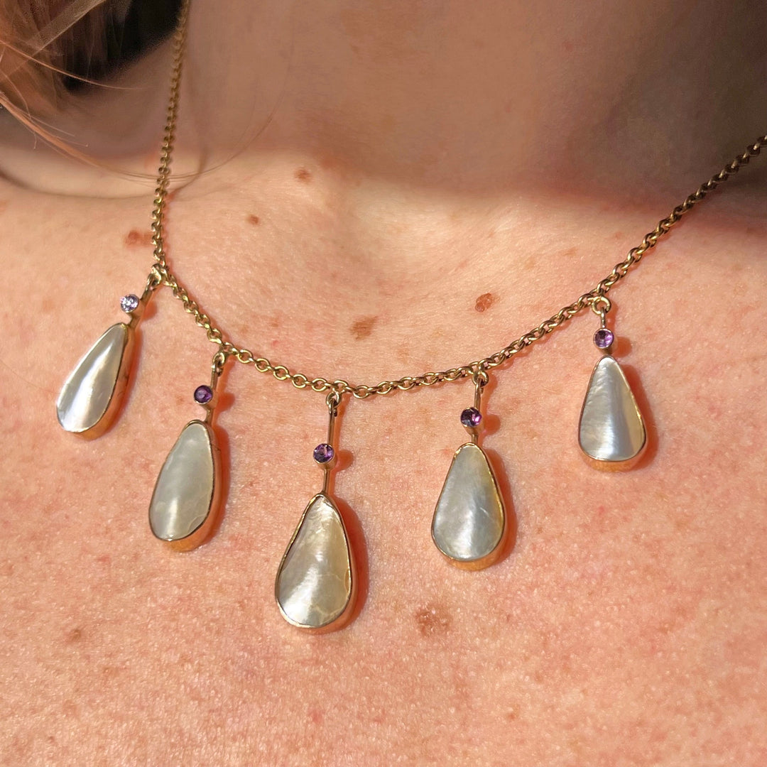 Detailed view of amethyst and pearl shell pendant