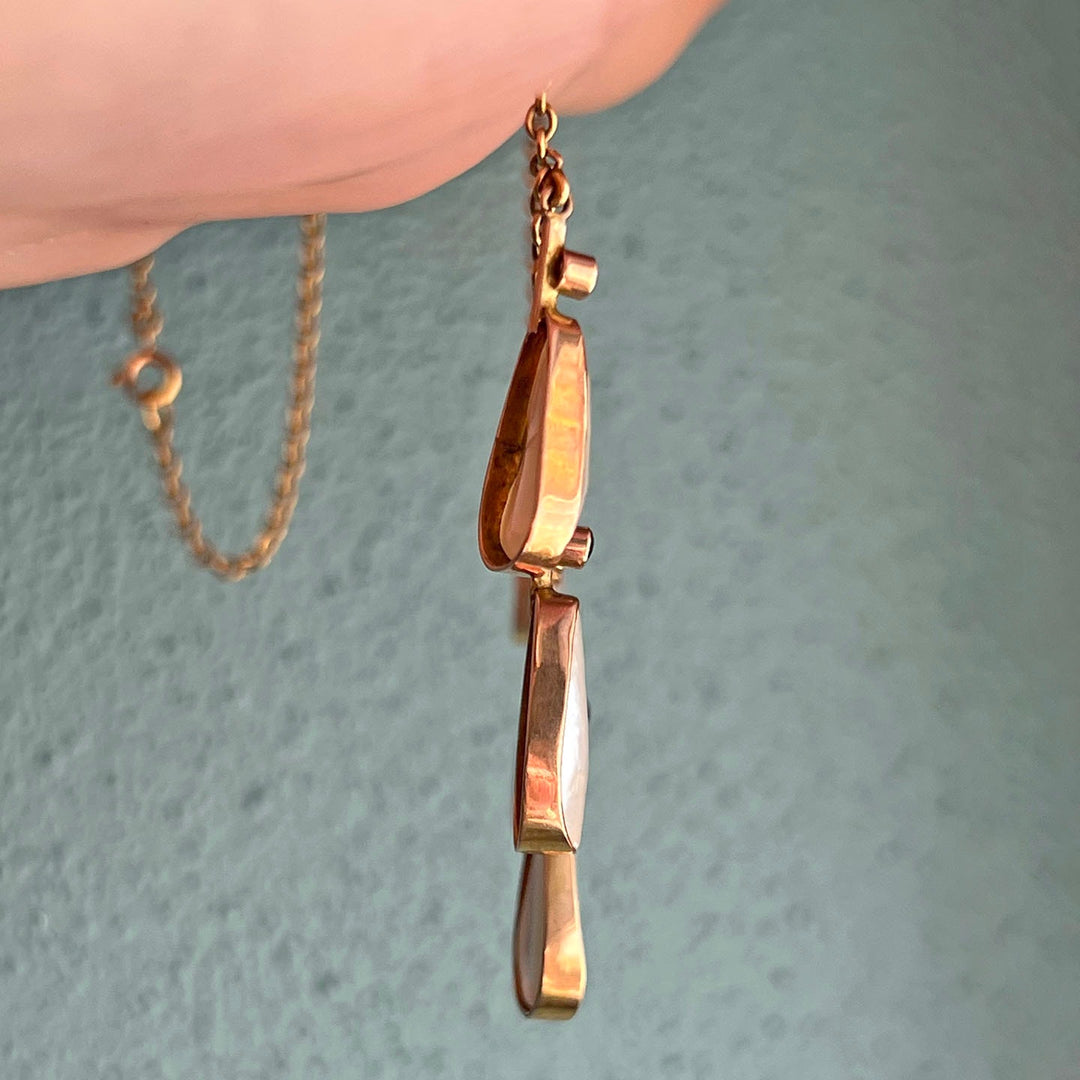 Side profile of antique gold pendant necklace