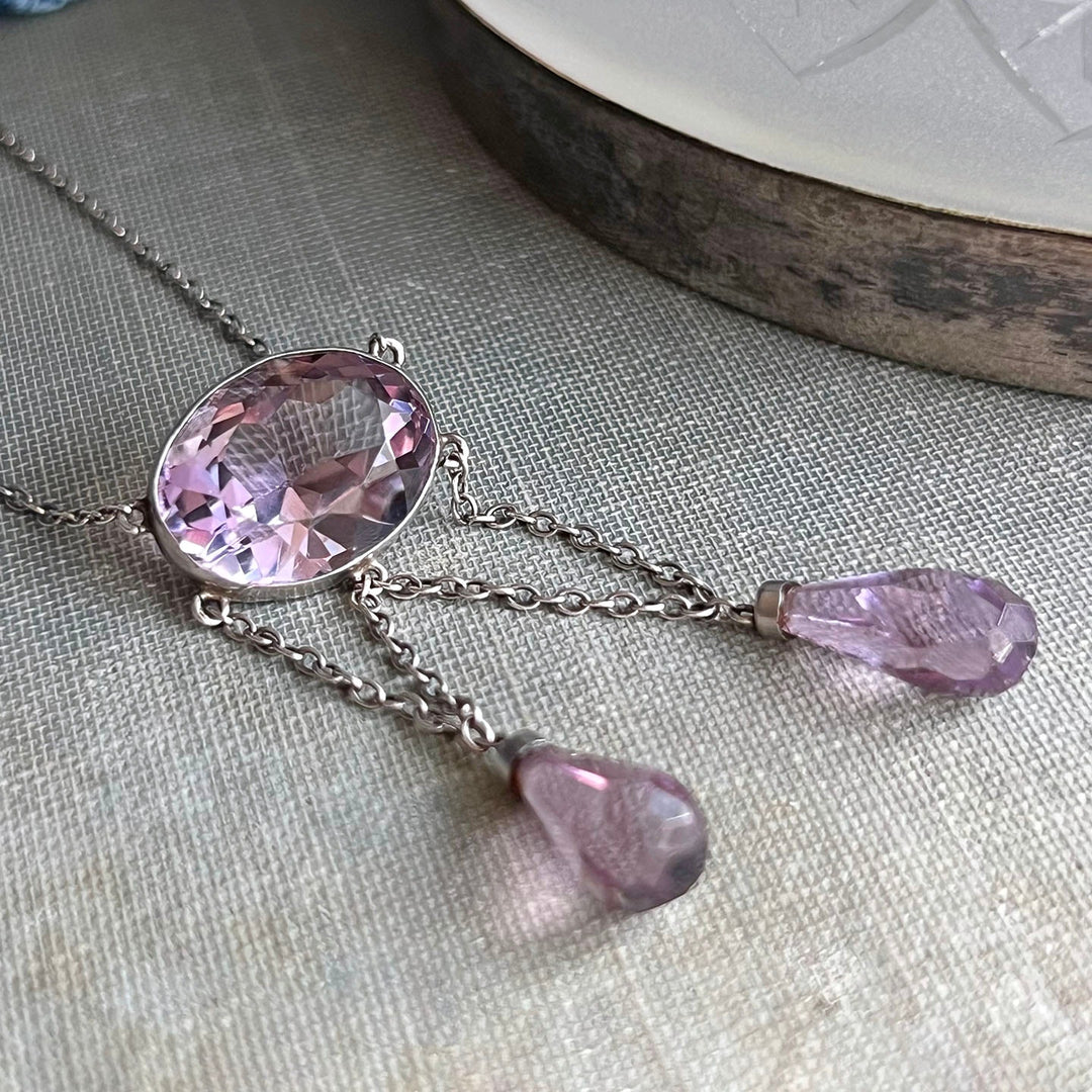 Close up purple amethyst stones antique silver necklace