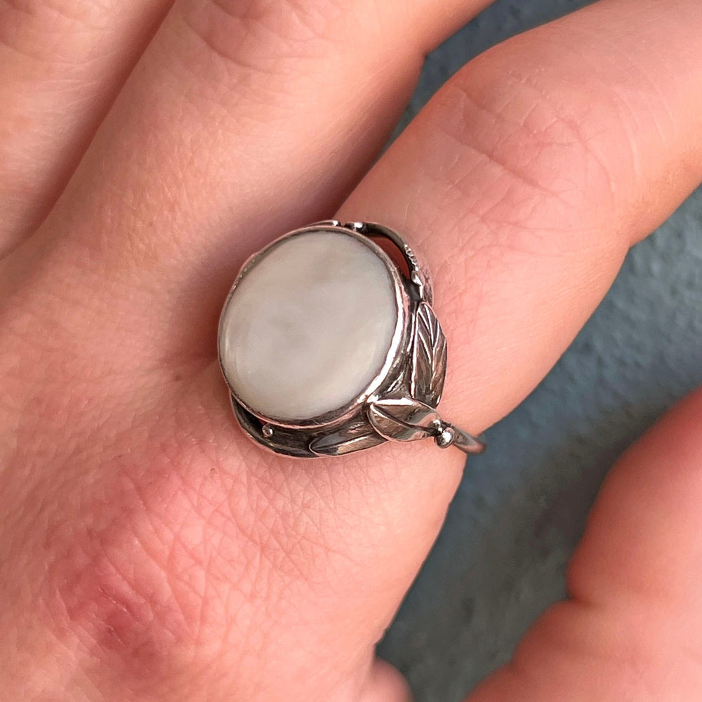 Detailed view of silver and shell setting