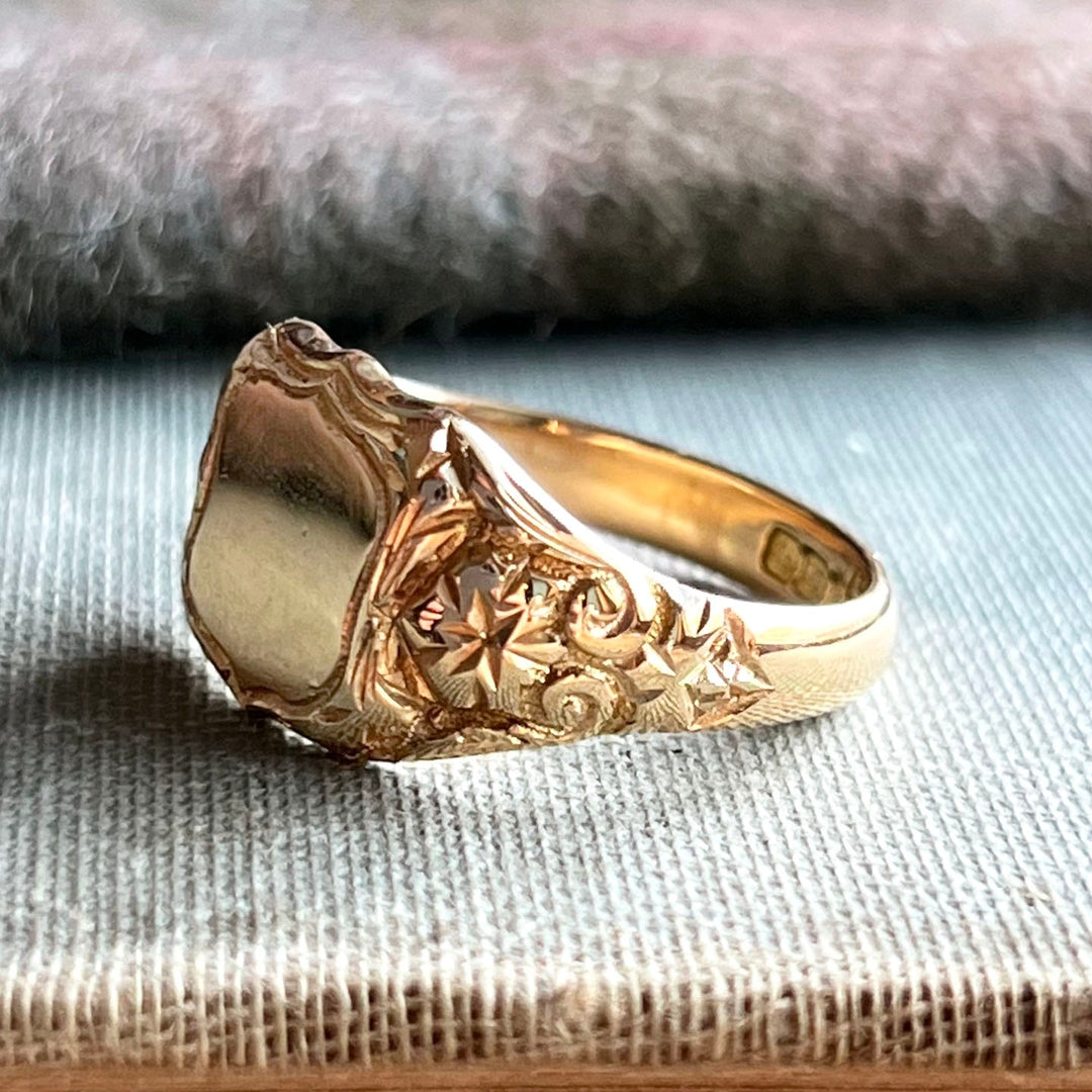 Vintage gold signet ring engraving detail on shoulders