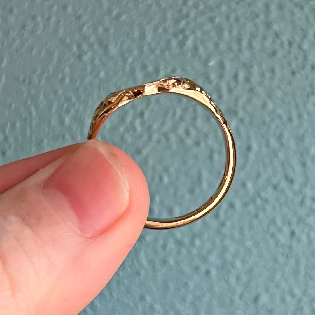 Close up of engraved shoulders on antique gold signet ring