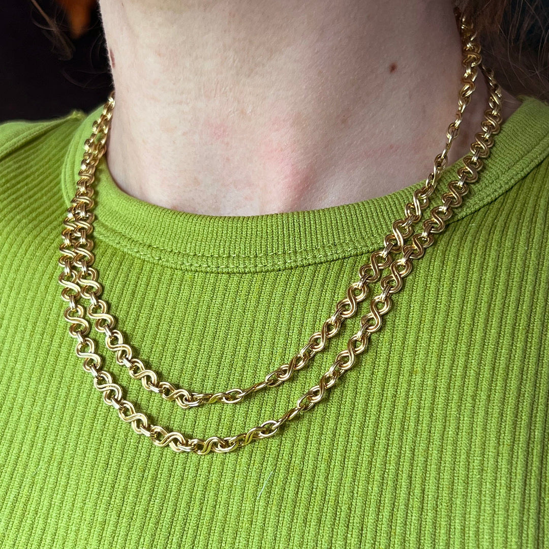 Art Deco 1920s gold chain necklace on display