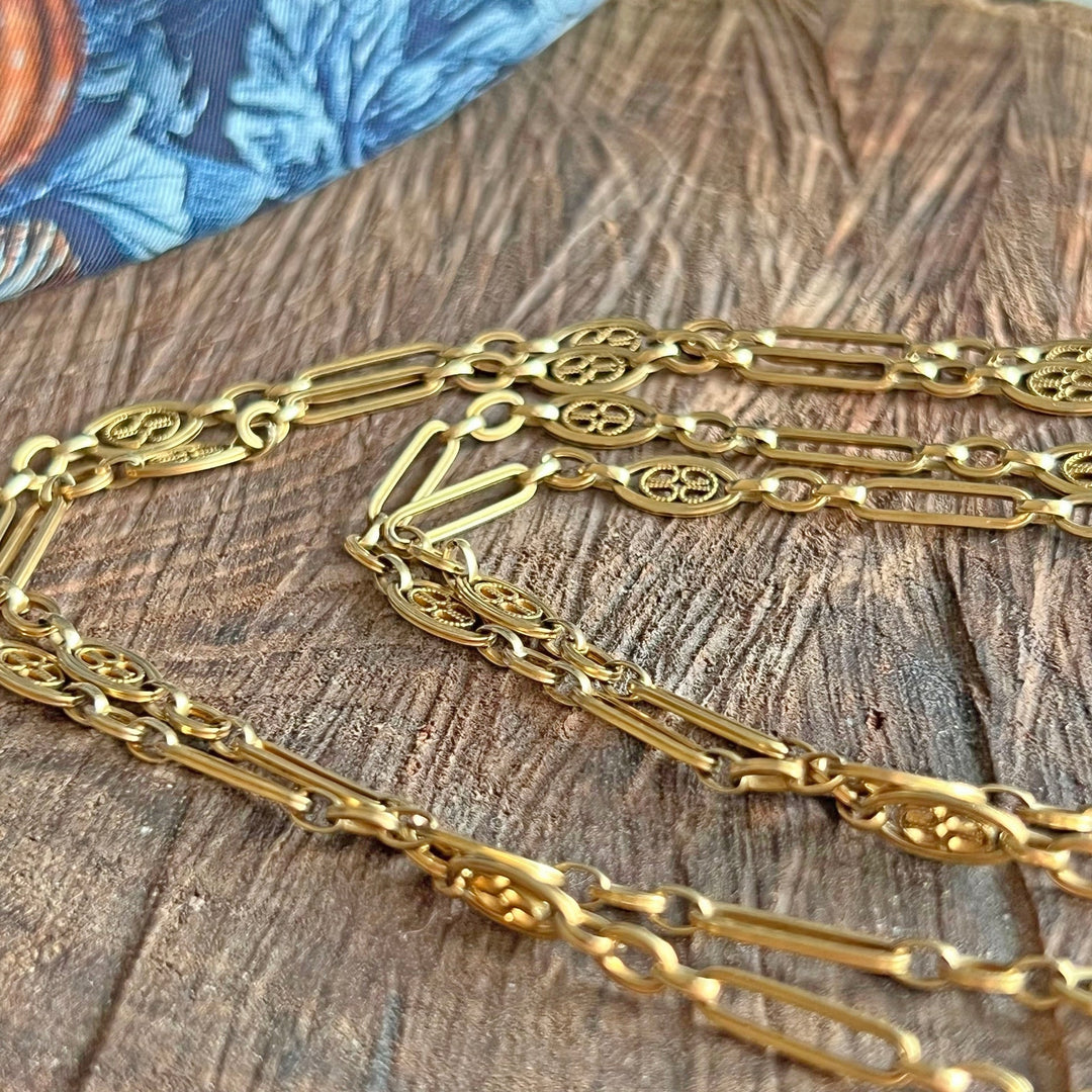 Close up antique gold elongated links chain necklace
