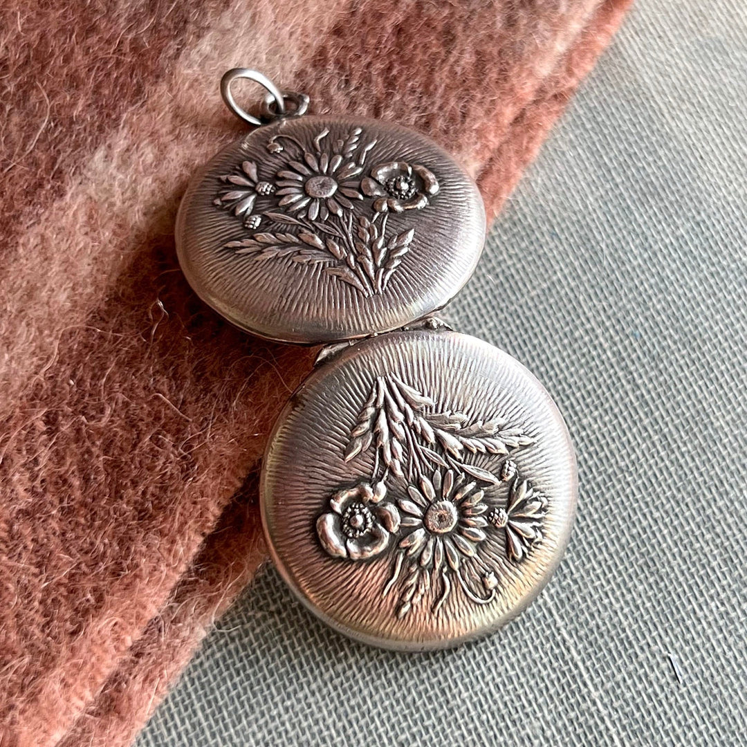 Back detail repoussé floral pattern antique silver locket