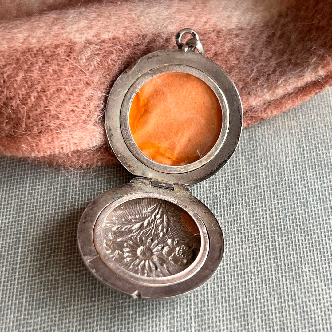 Inside detail repoussé floral pattern antique silver locket