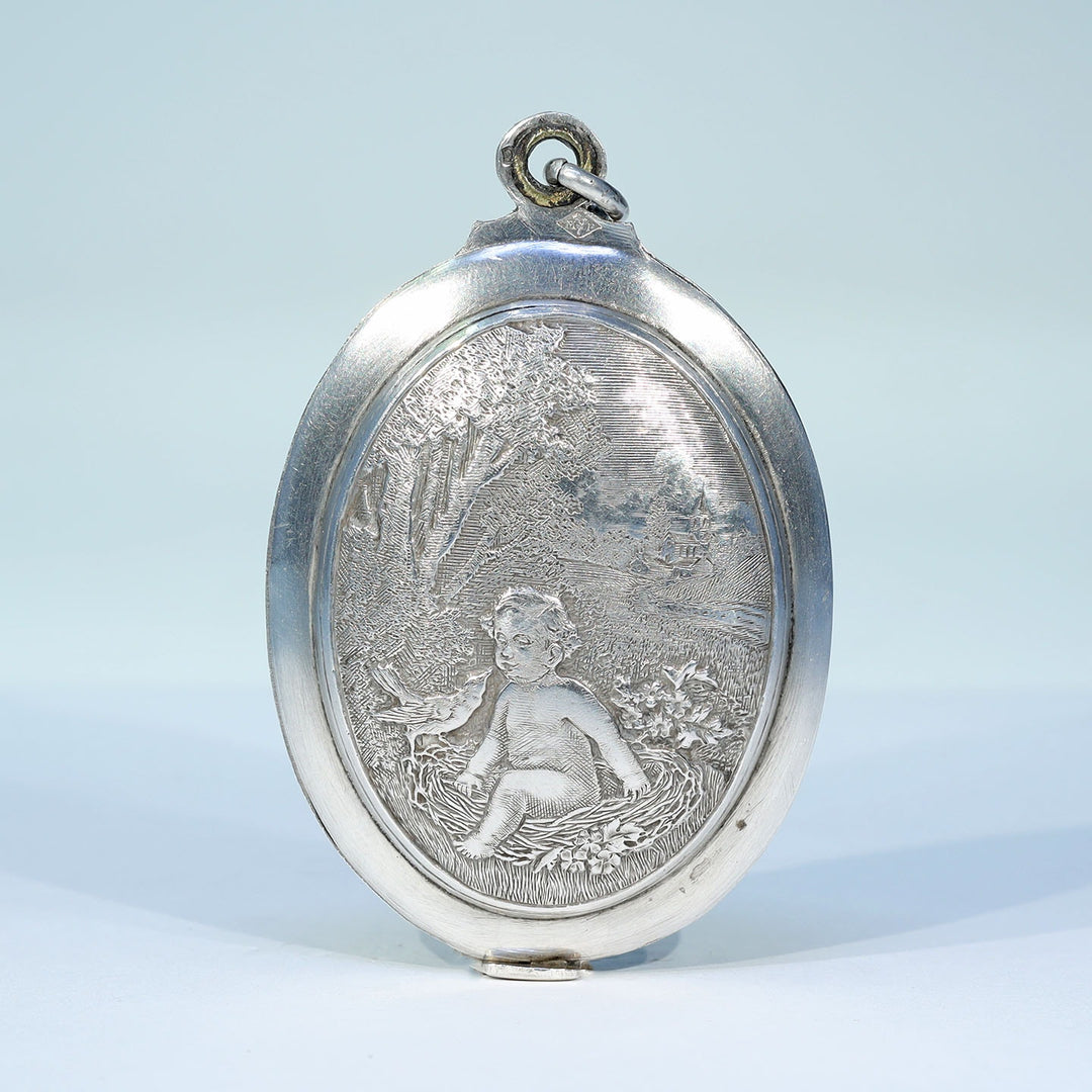 Antique French silver baby in nest slide locket circa 1880