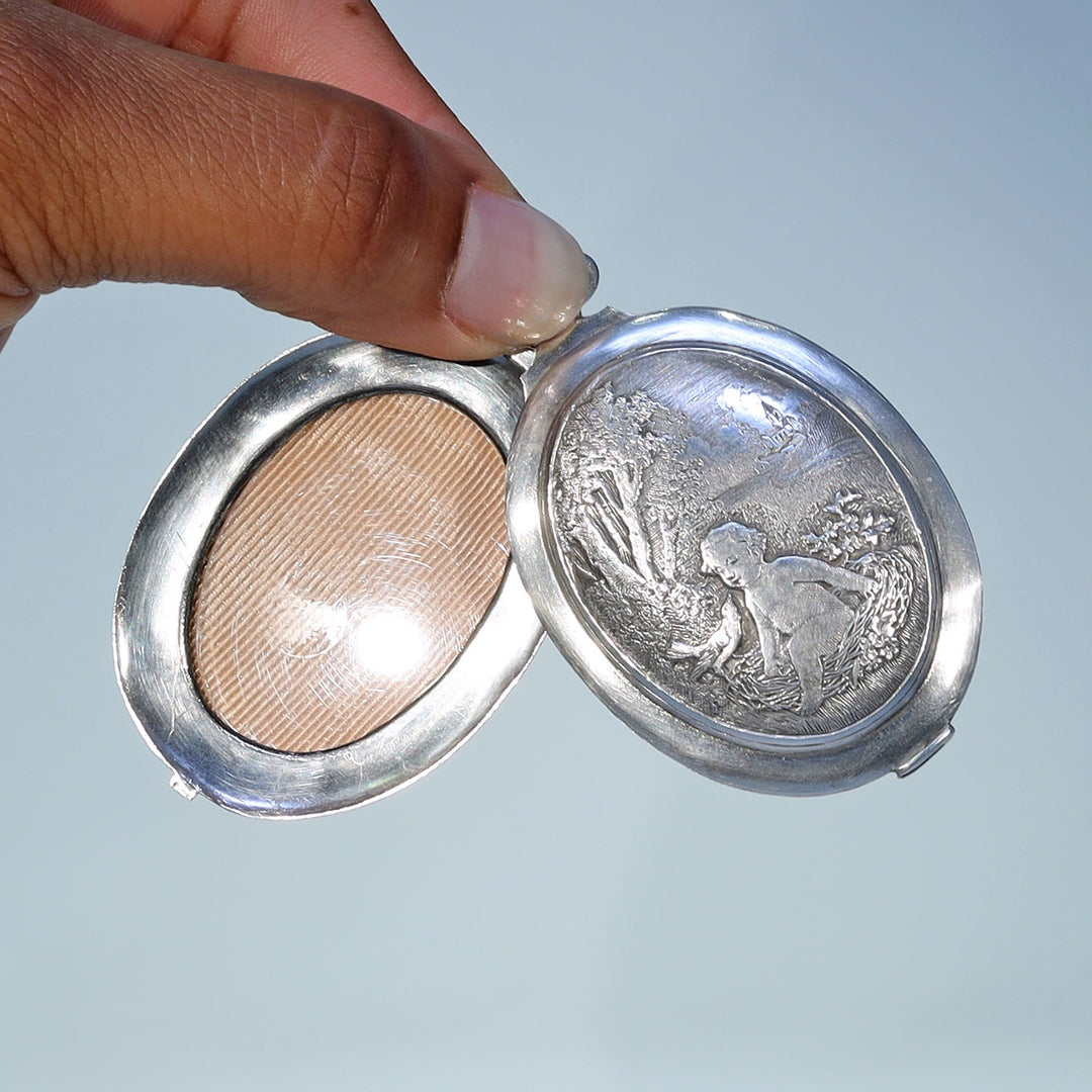 Victorian era French silver locket with baby and bird nest motif