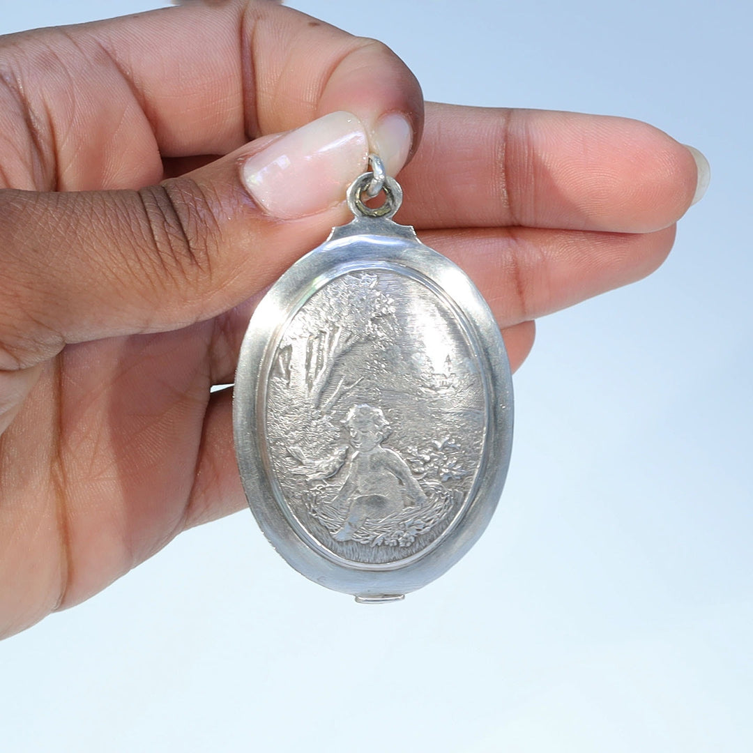 Collectible French silver slide locket with figural design