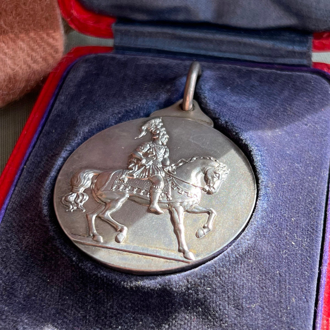 Close up antique equestrian medal horse design sterling silver