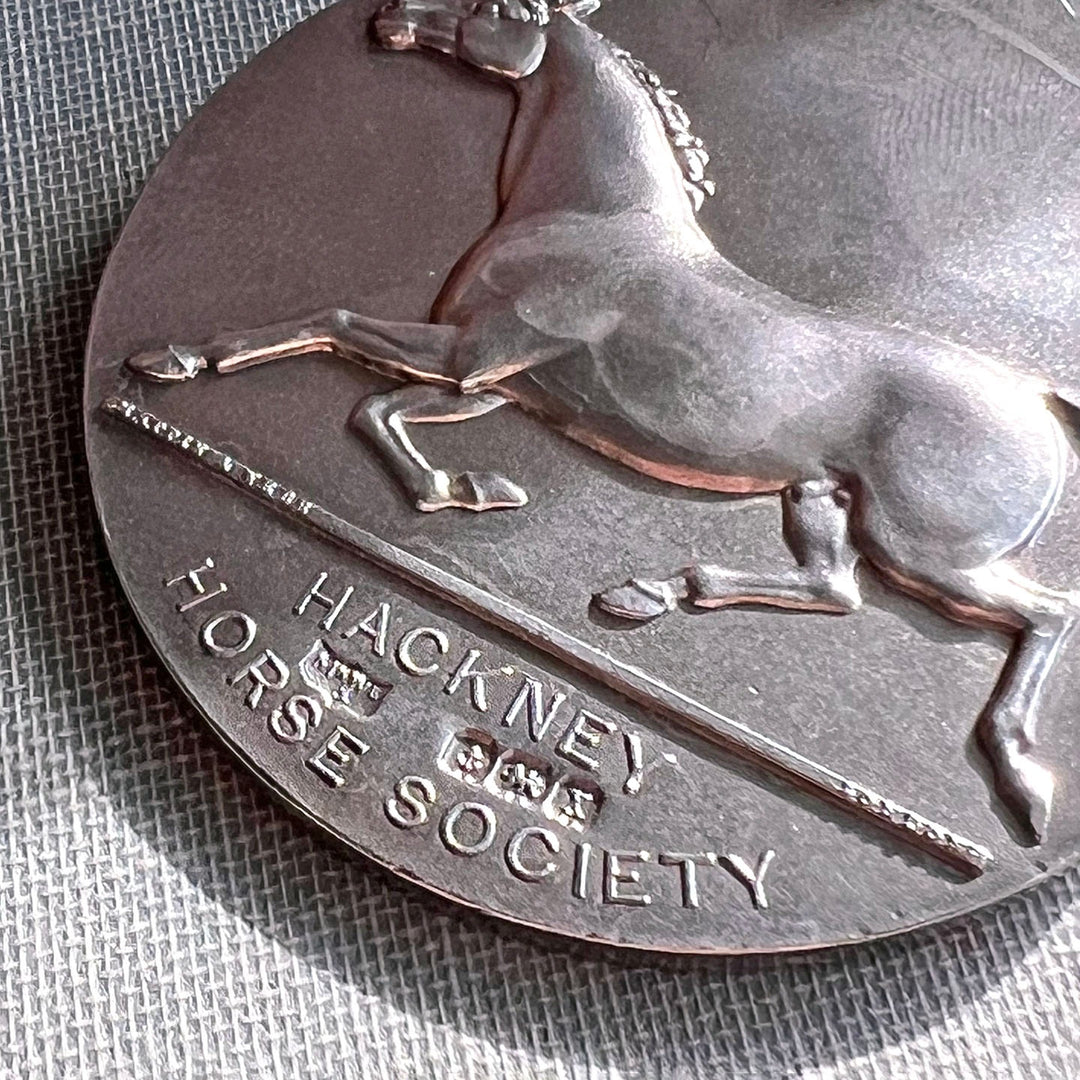 Close up antique equestrian medal horse design sterling silver