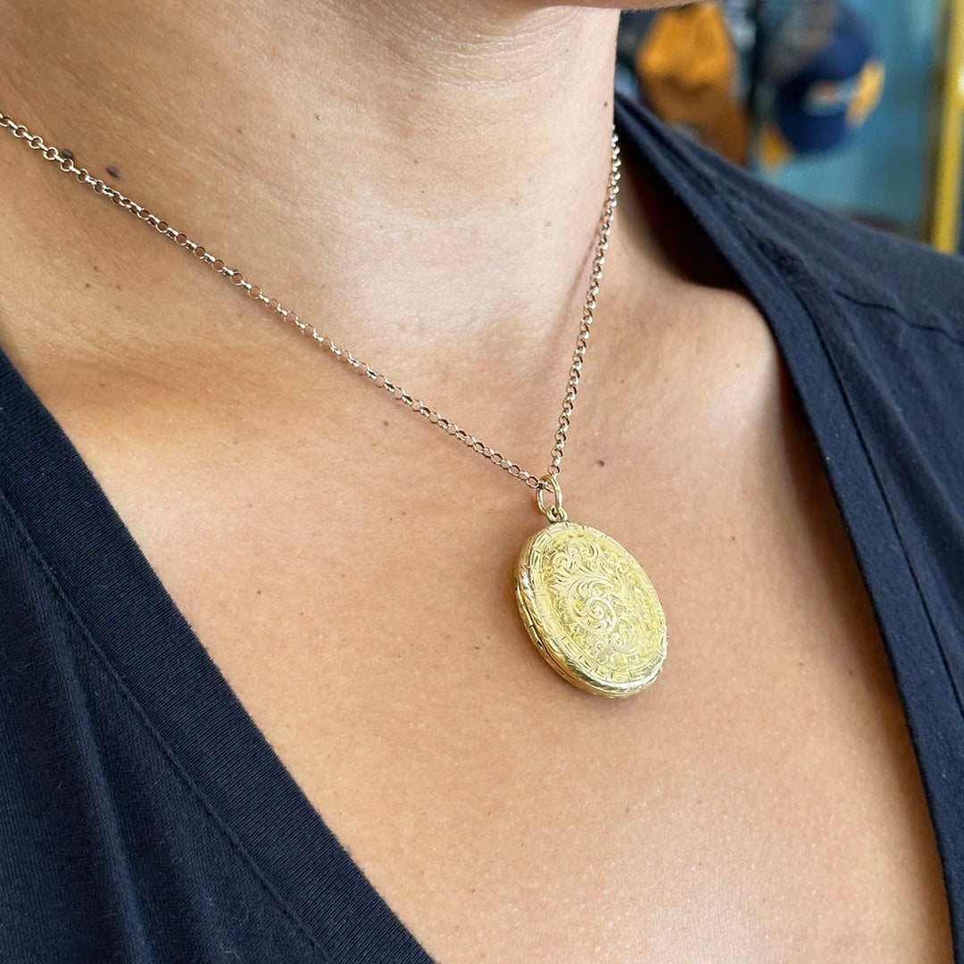 Victorian gold photo locket with elaborate floral engraving