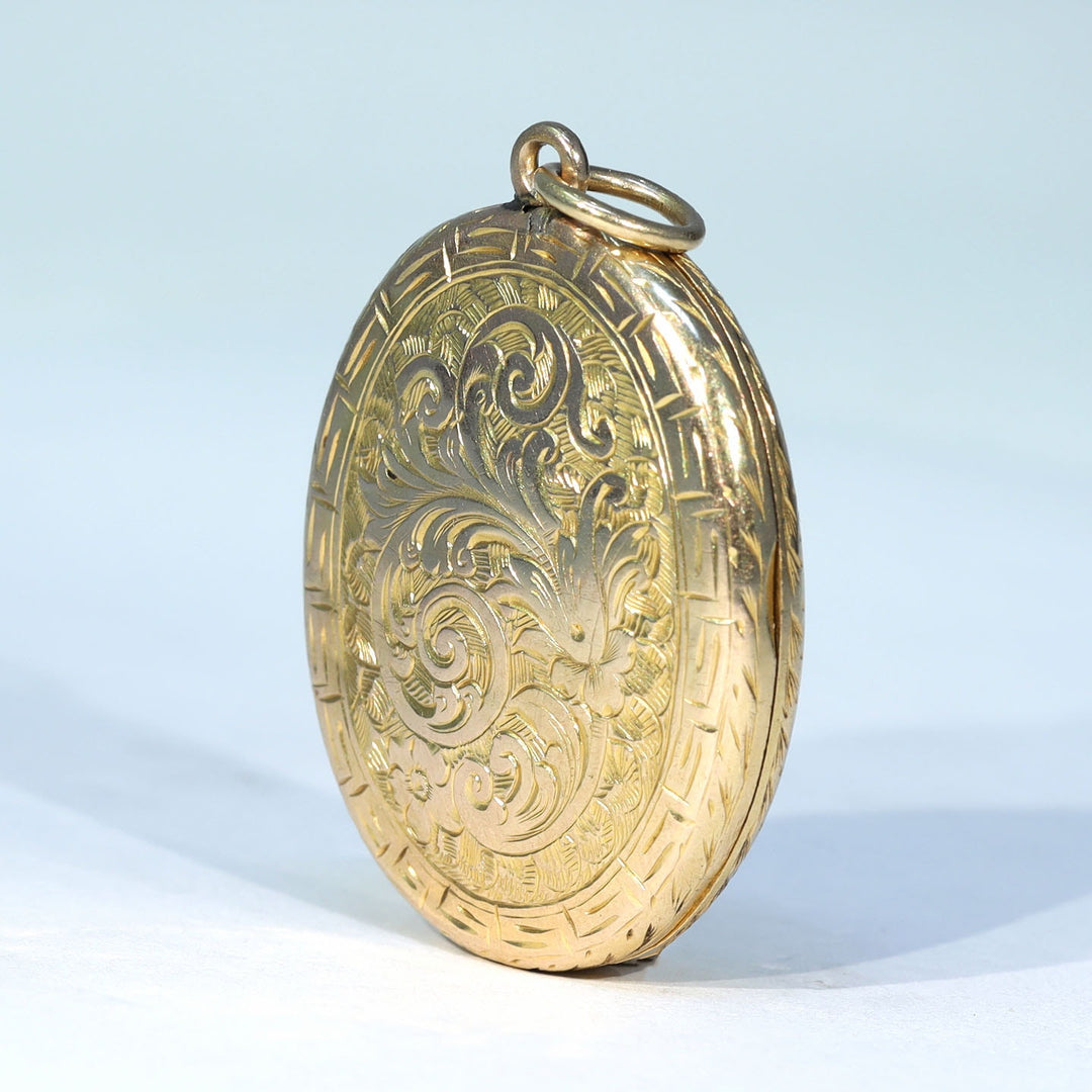 Richly engraved antique gold locket with geometric border