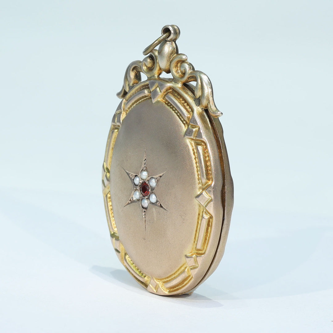Antique gold locket featuring garnet accents