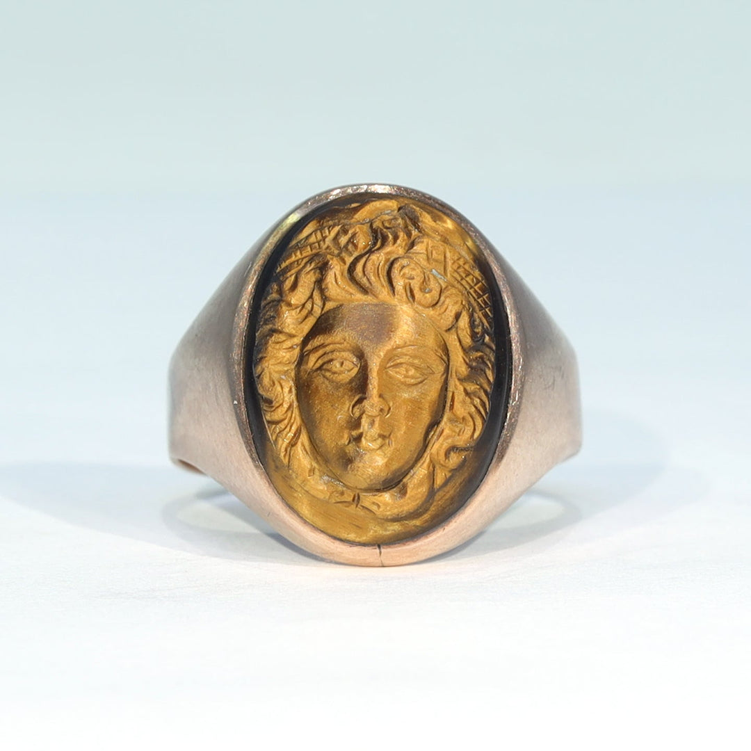 Oval gemstone cameo ring with flowing carved curls