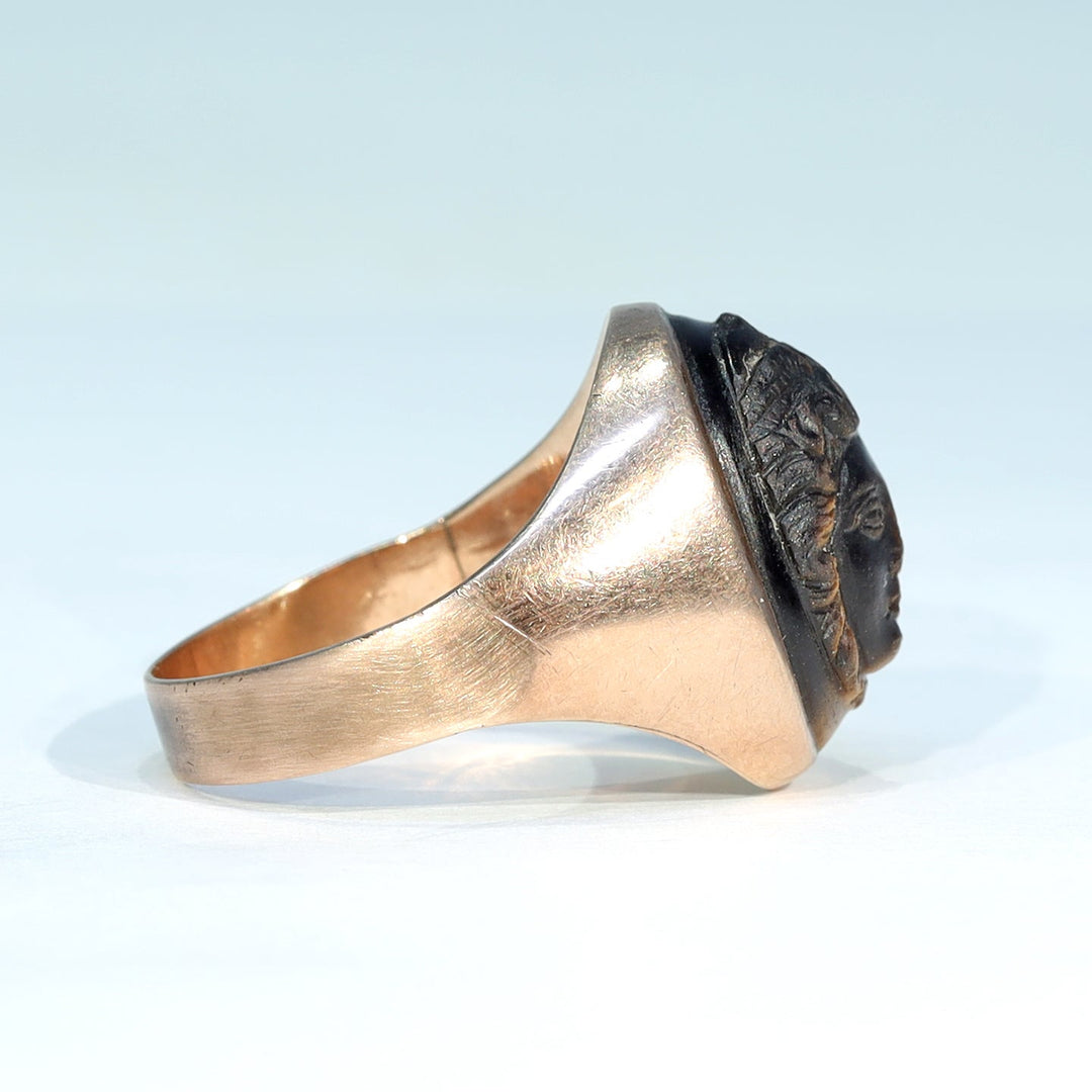 Close view of classical face carved into tiger's eye gemstone