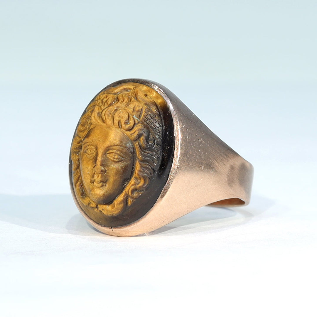 Close view of classical face carved into tiger's eye gemstone