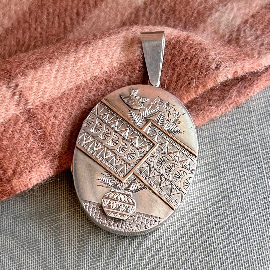 Antique Victorian embossed silver bird floral locket
