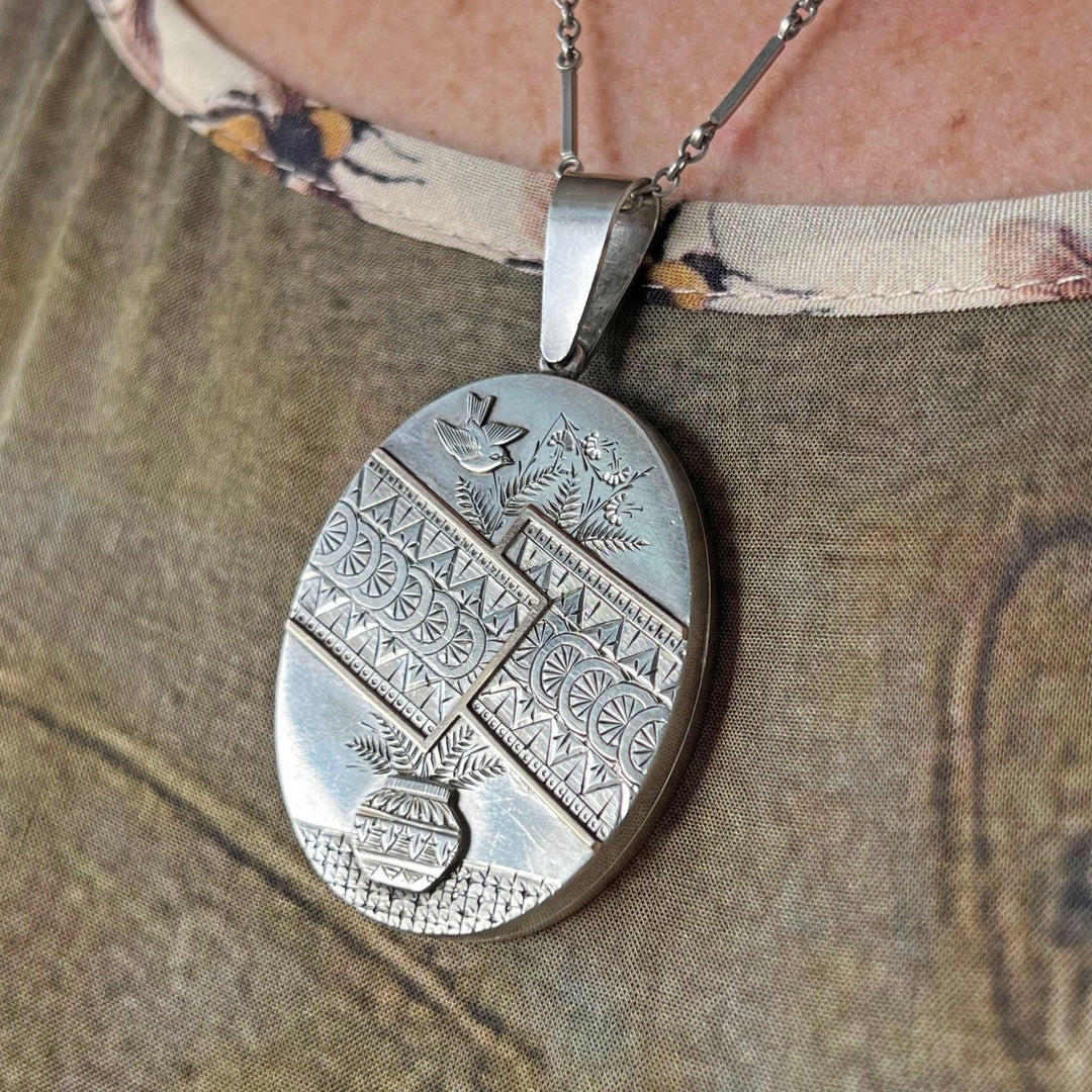 Detailed repoussé work on antique silver pendant