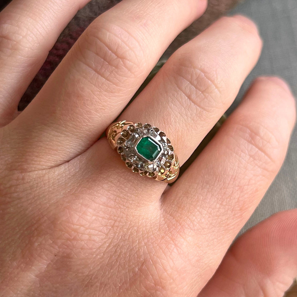 Vintage emerald and diamond ring on hand