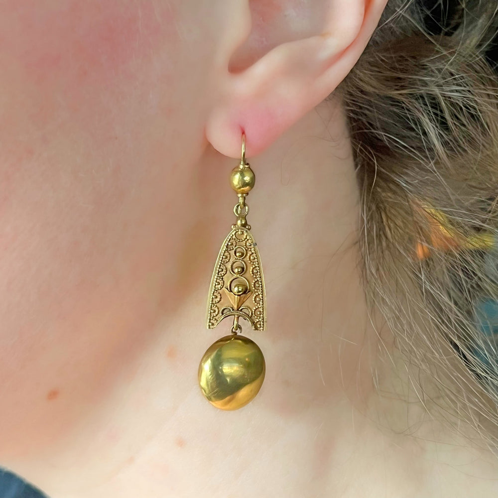 Victorian gold drop earrings worn on ear antique style