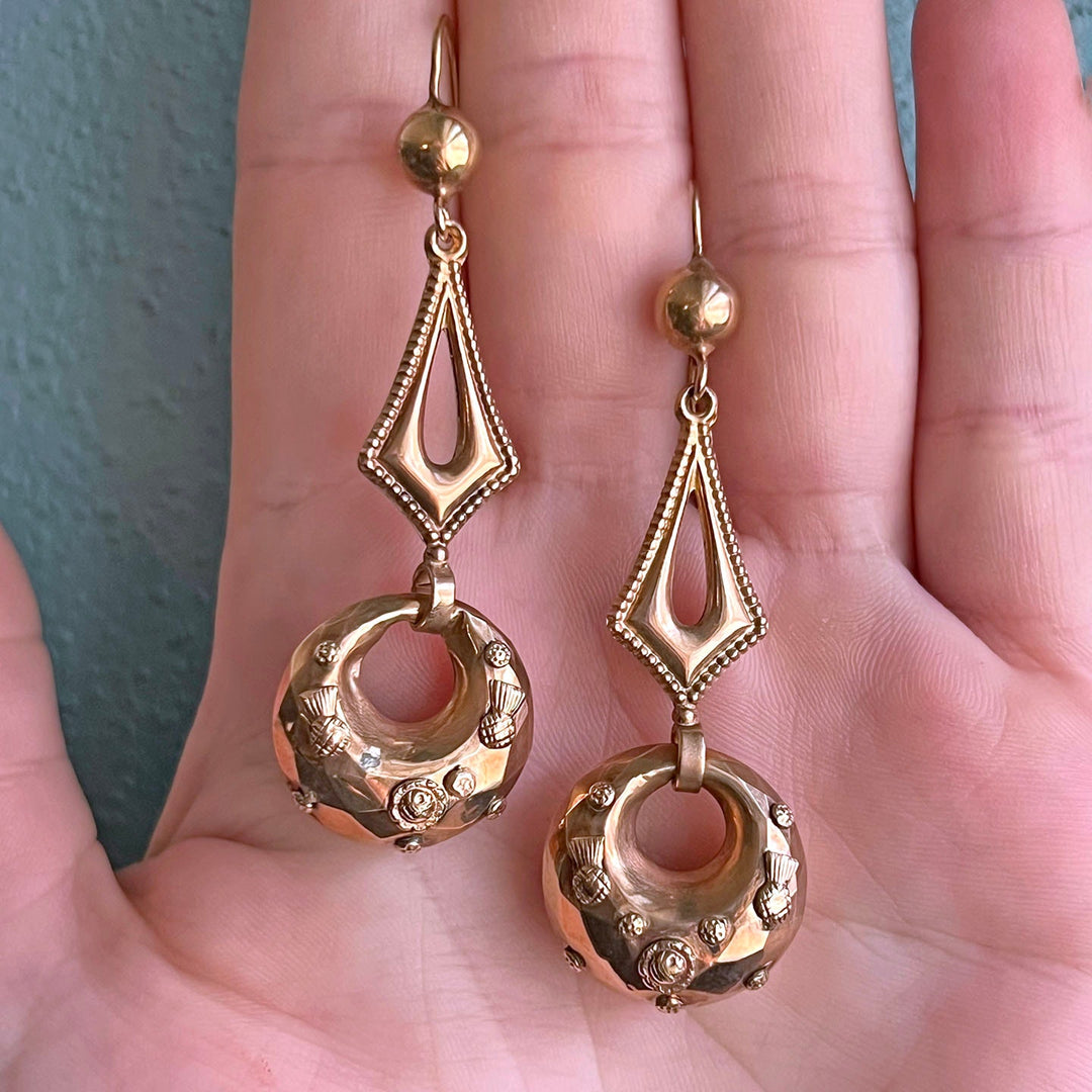 Close up antique embossed gold earrings texture detail