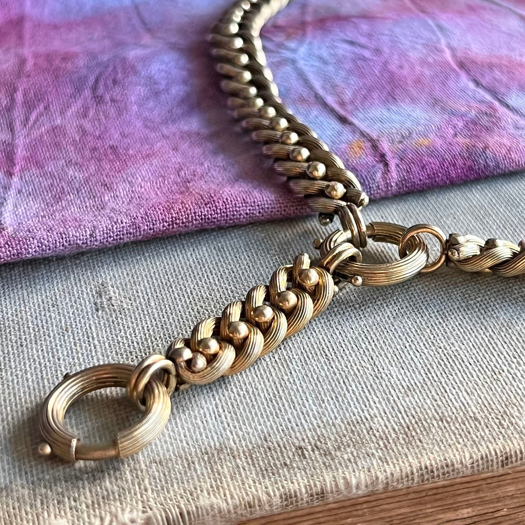 Close up antique gold link necklace detailed links