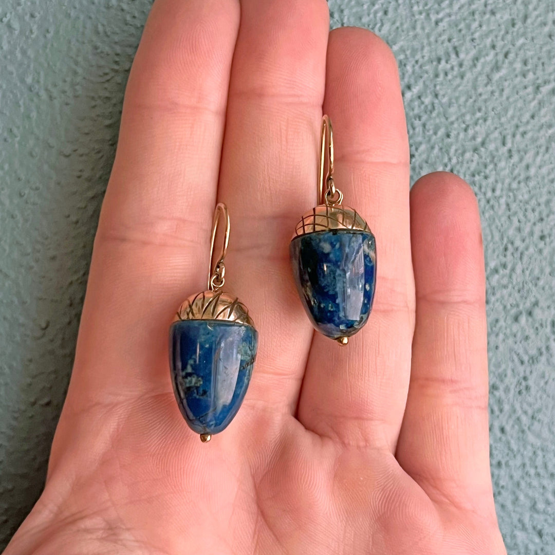 Close up deep blue lapis stones acorn motif earrings