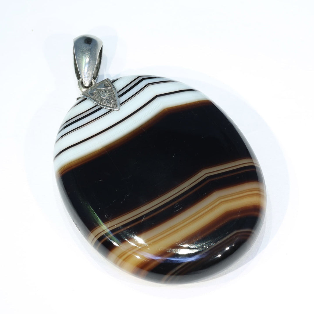 Close view of engraved silver bale on antique agate pendant