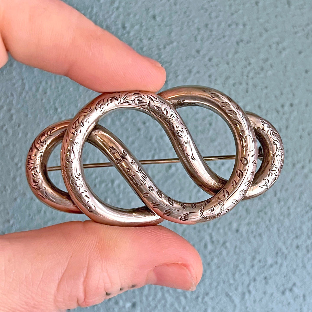 Detailed engraving on antique knot jewelry