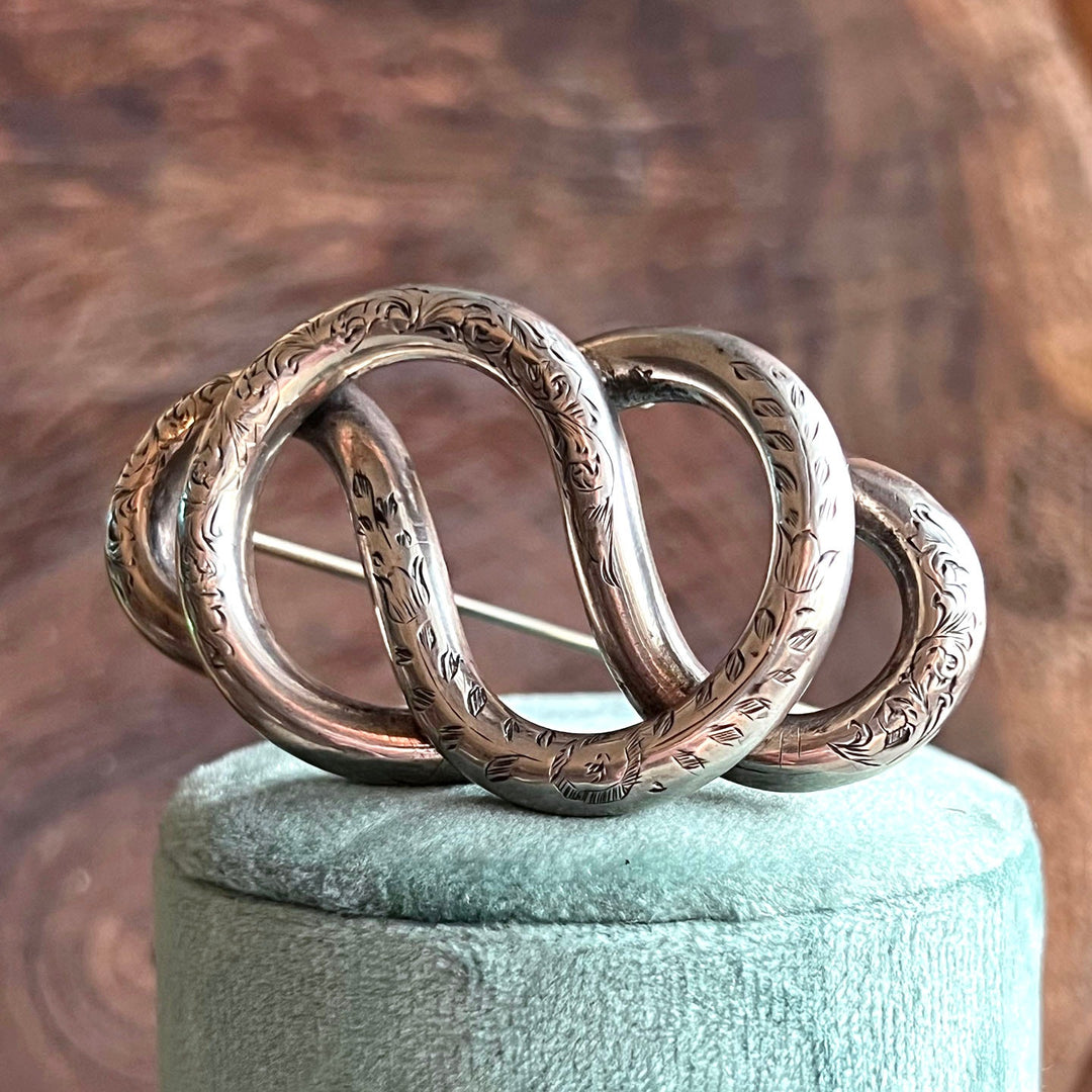 Detailed engraving on antique knot jewelry