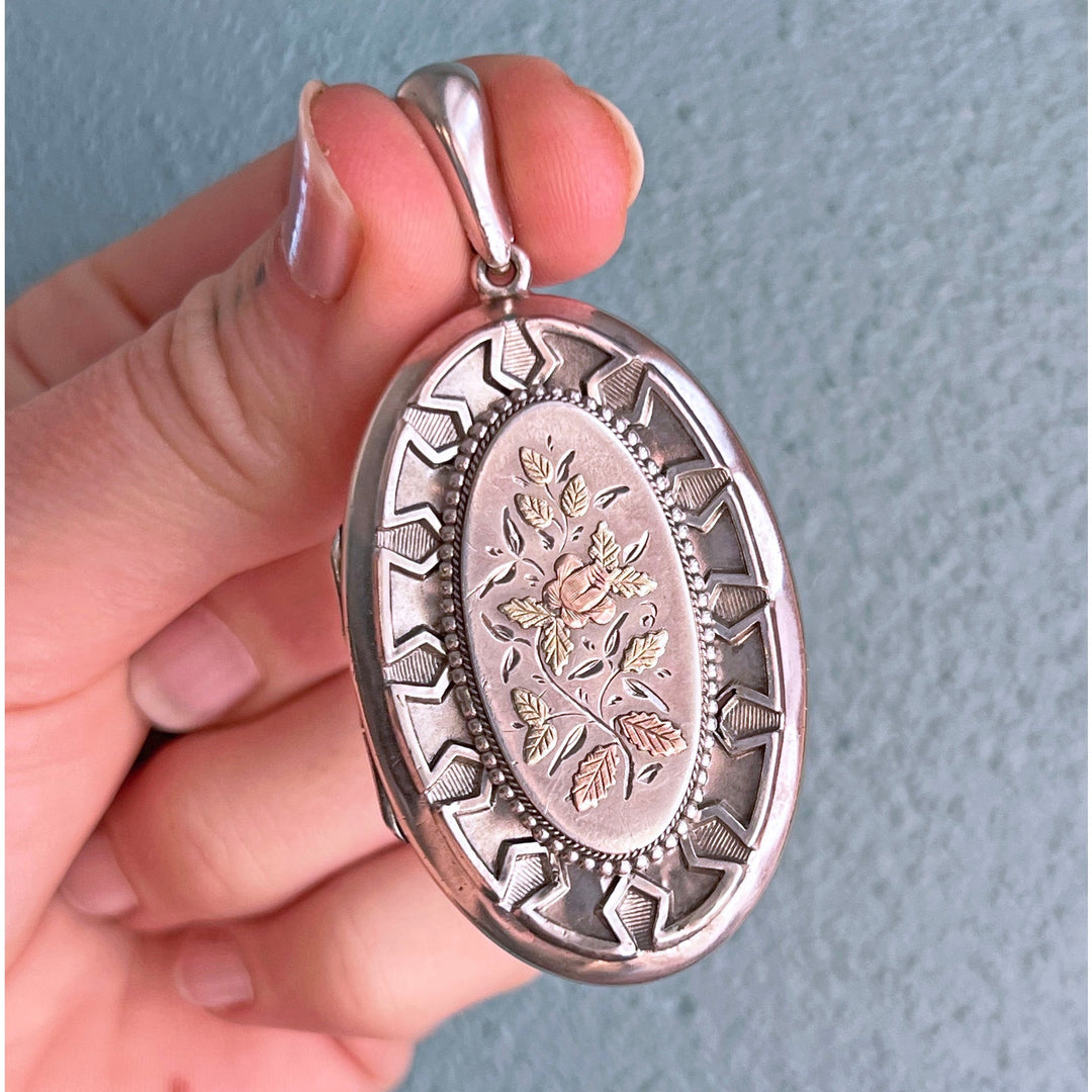 Close up antique floral engraving silver locket