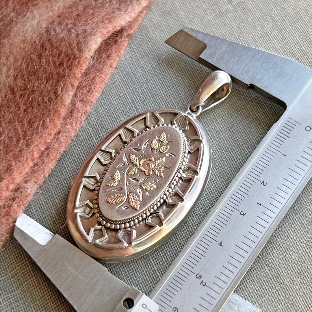Close up antique floral engraving silver locket
