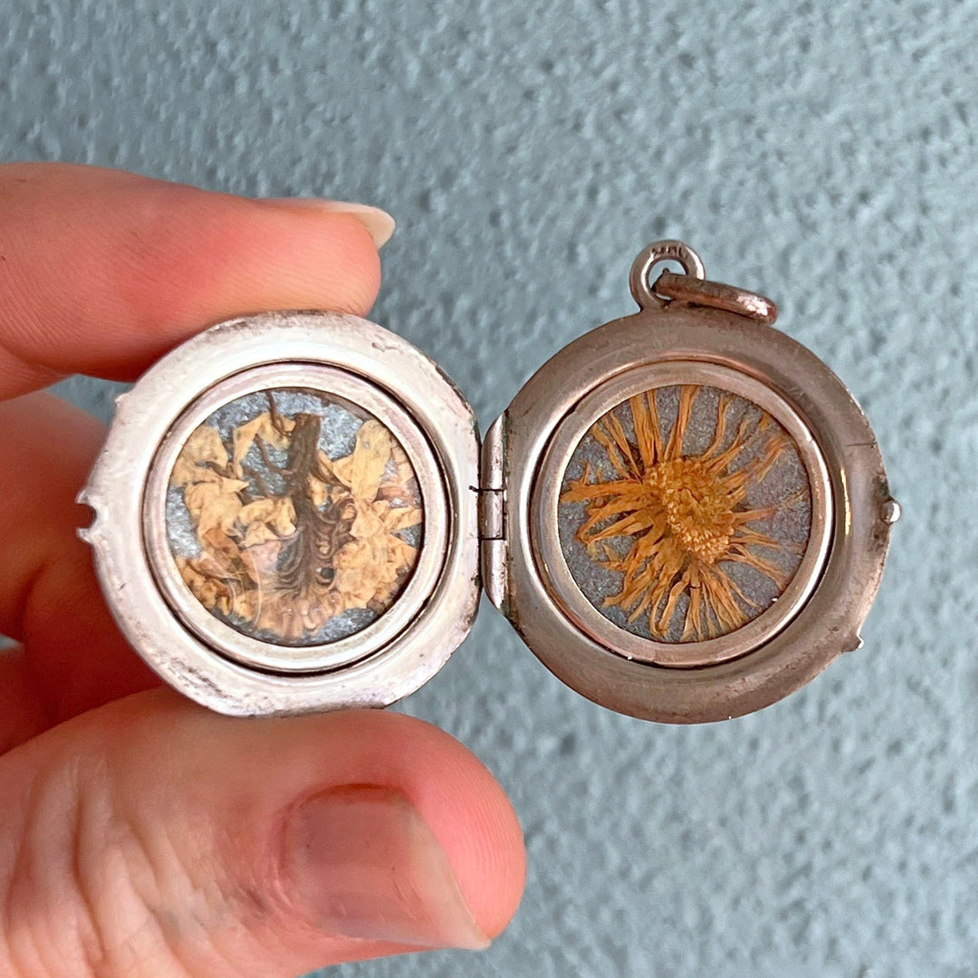 Victorian silver locket with preserved flowers