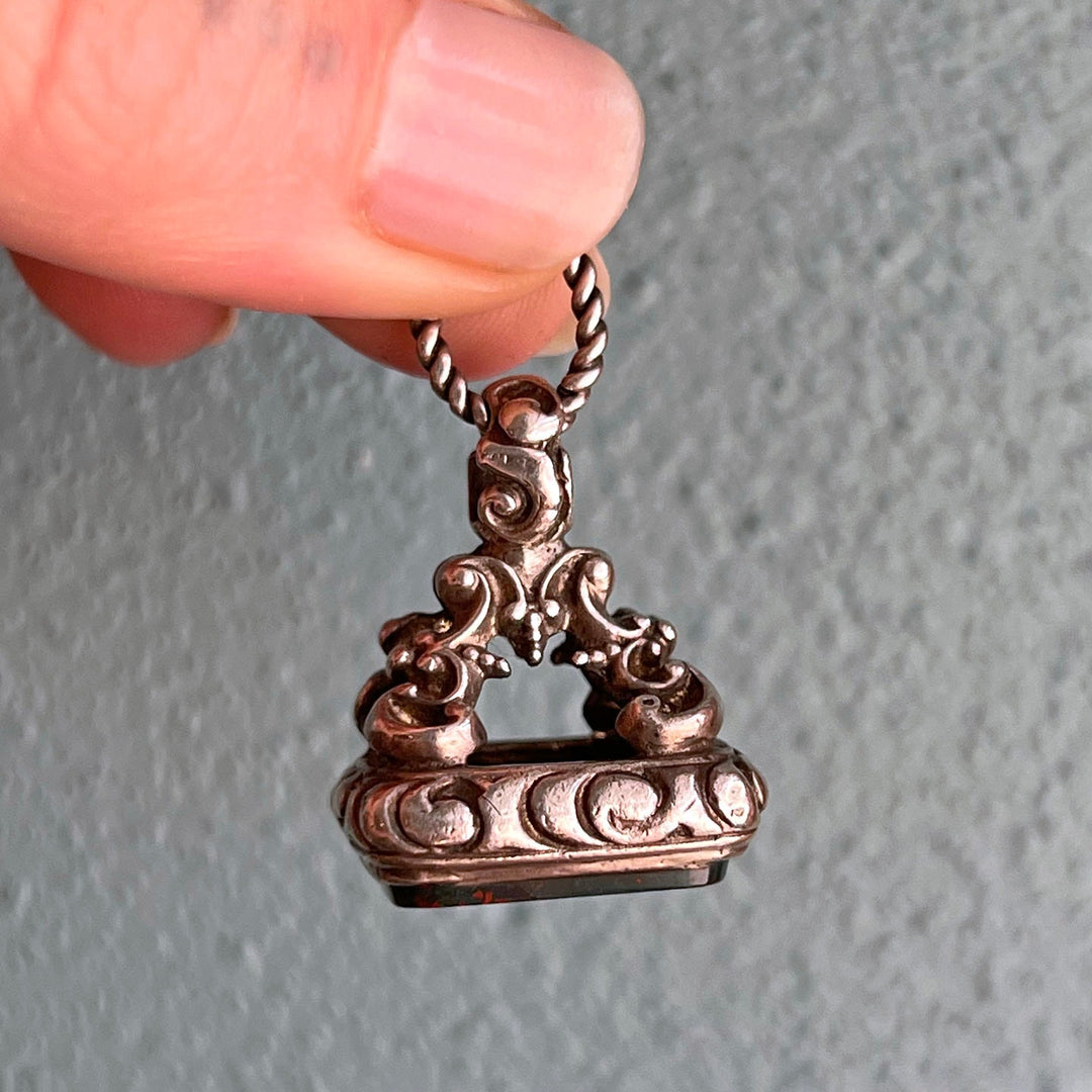Side view silver repoussé fob detailed design