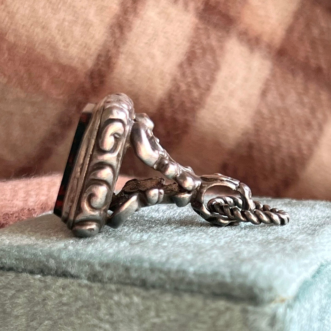 Side view silver repoussé fob detailed design