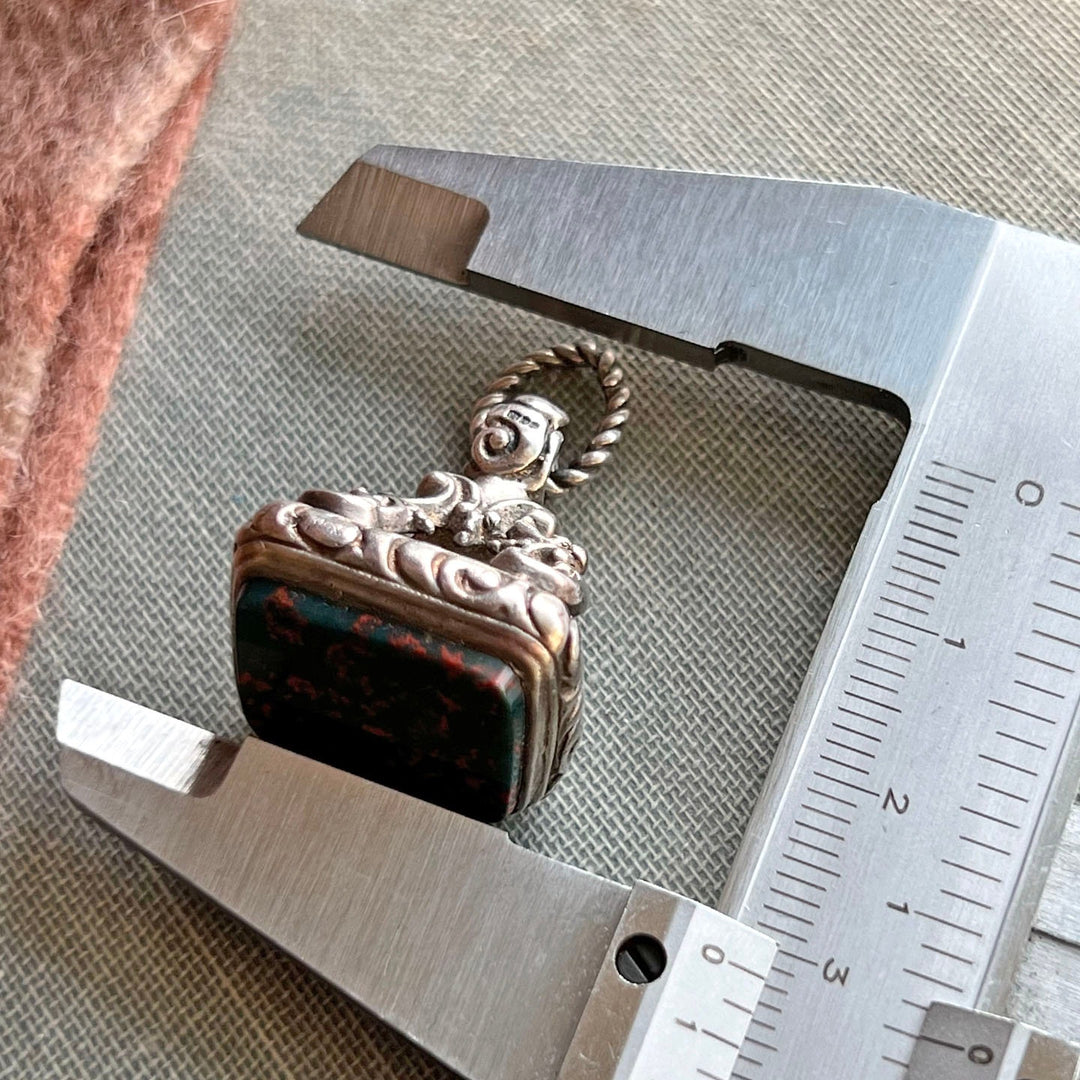 Detail of engraved silver fob setting with bloodstone