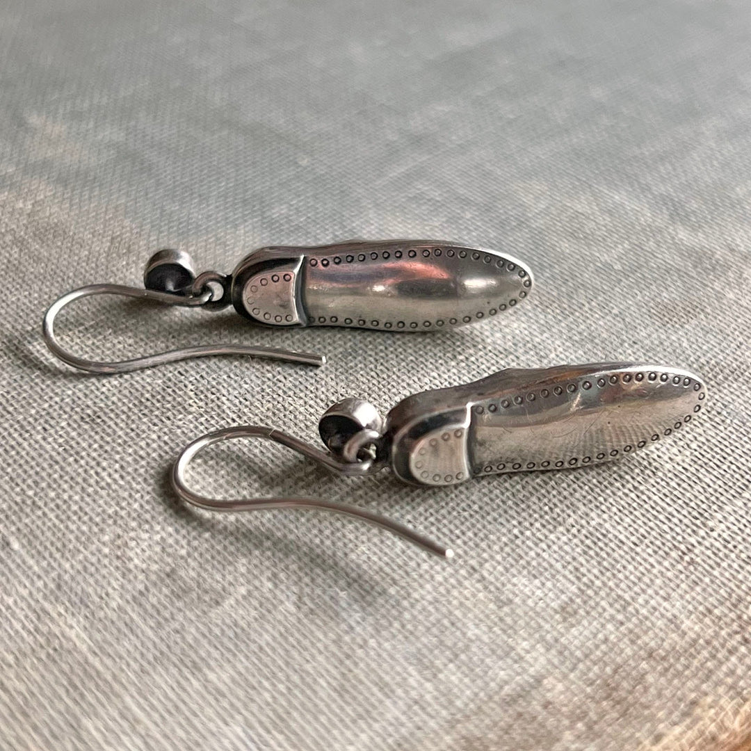 Detailed view of silver shoe charms