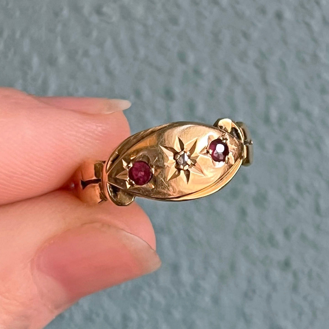 Close up ruby and diamond starburst setting Victorian ring