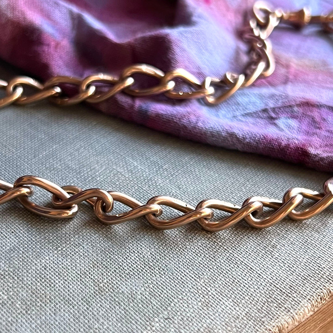 Close up antique Albert watch chain showing rich gold curb links